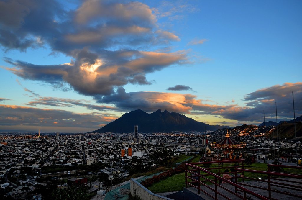 A photo of the sun setting behind Cerro de la Silla mountain in Monterrey, Mexico.
