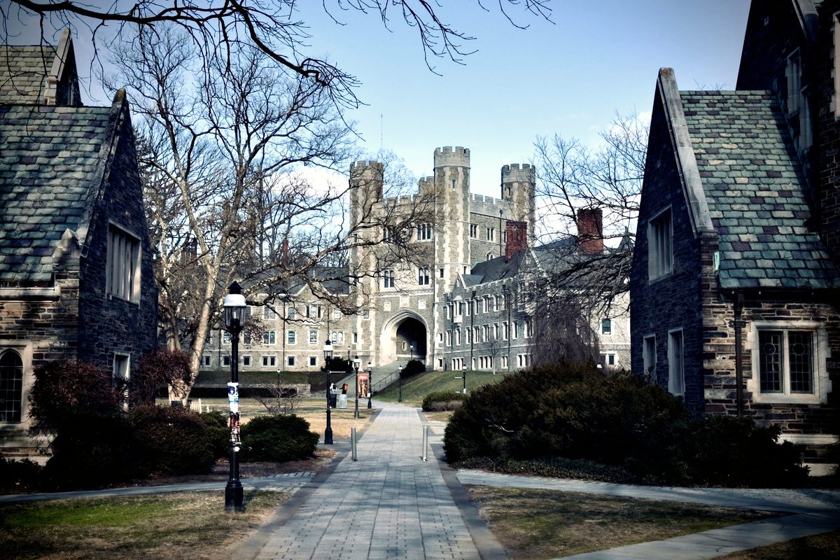 Stone Gothic buildings on the Princeton University campus framing a path toward an arched tower