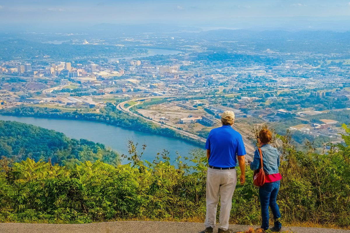 Two travelers at the Lookout Mountain overlook taking in Chattanooga and the bend of the Tennessee River below