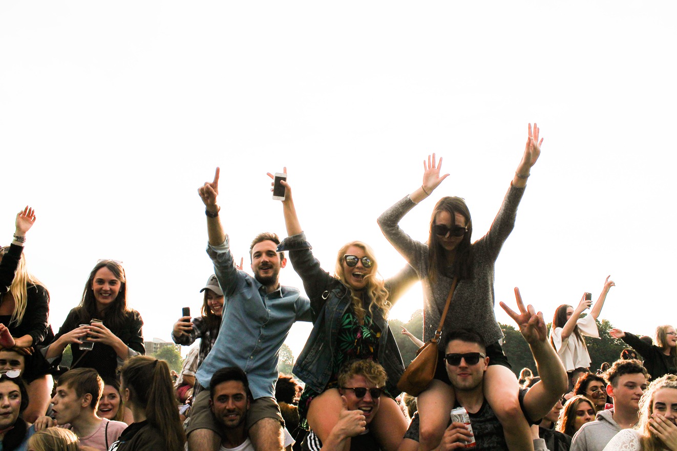 Men and women enjoying a summer music festival