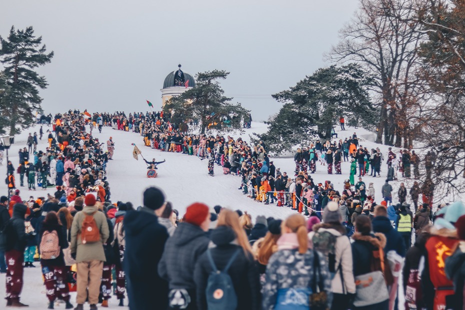 A crowd watches a fun sledding race
