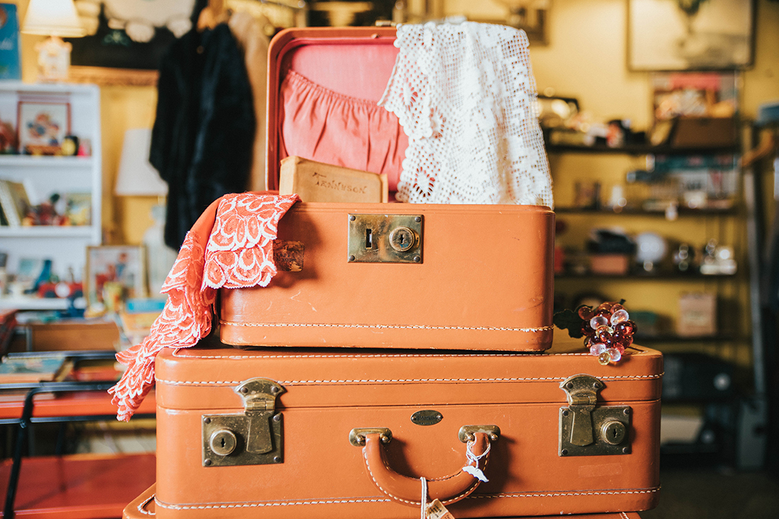 Photo of a stack of suitcases being packed for a trip.