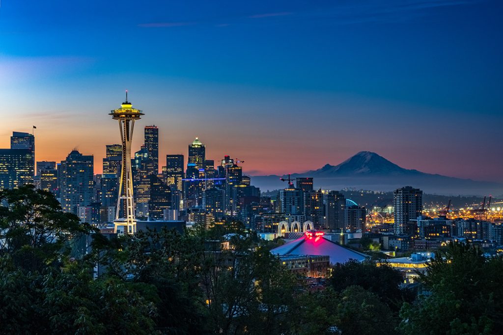 Photo of the Seattle skyline at night, with a view of the Space Needle.