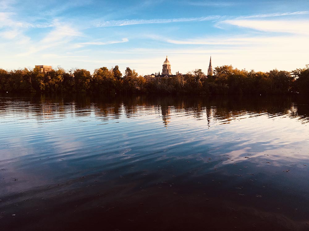 Photo of a lake at sunset in front of Notre Dame University in South Bend, Indiana.