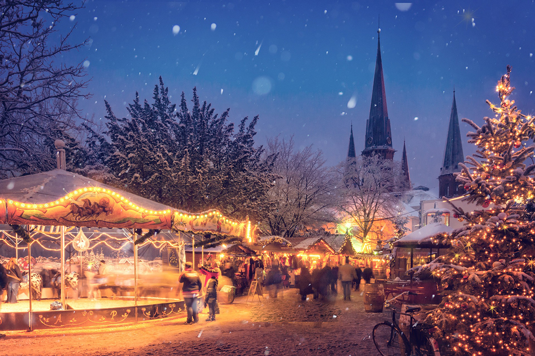 Photo of a Christmas market in Germany, as snow gently falls.