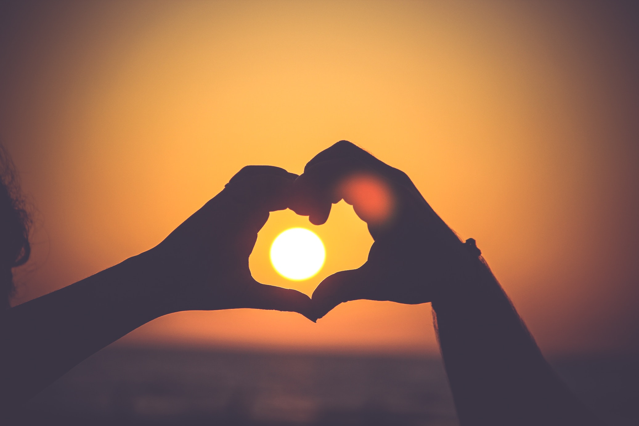 Romantic image of a couple watching the sunset.