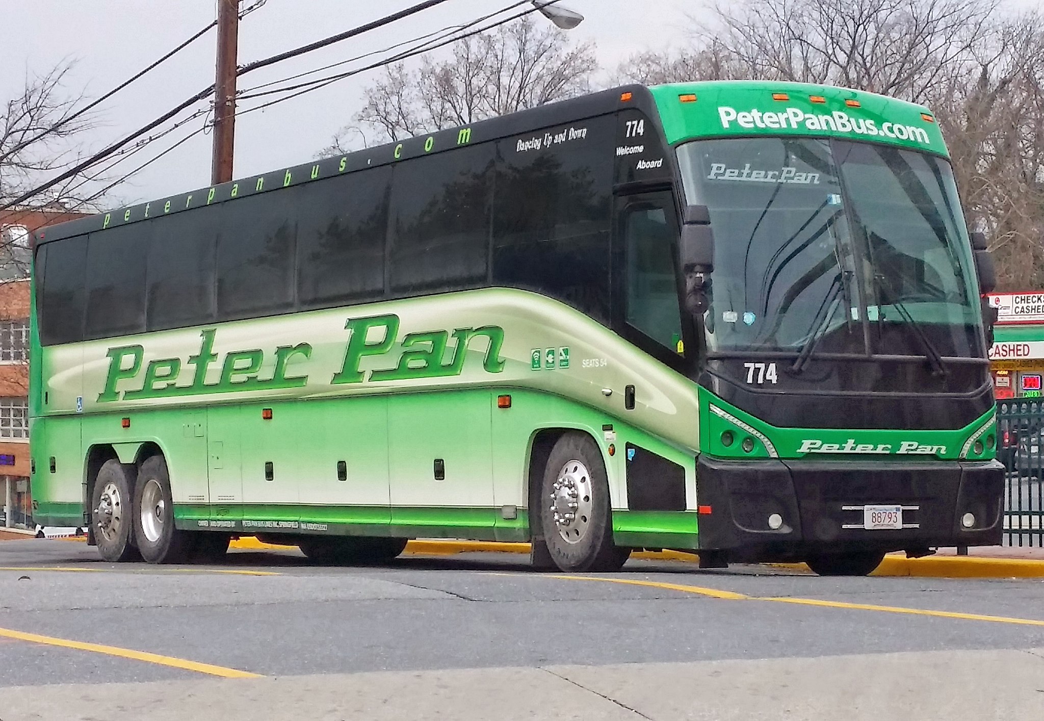 Photo of a Peter Pan Bus Lines bus at a curbside stop.