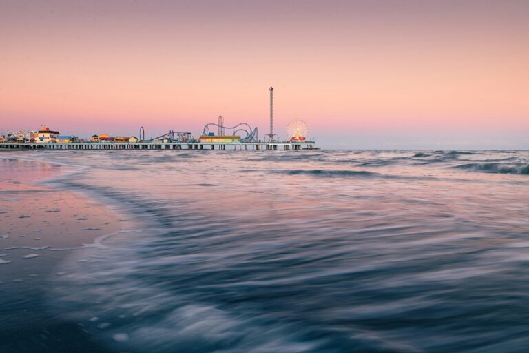 Pleasure Pier in Galveston at sunset with the beach in the foreground