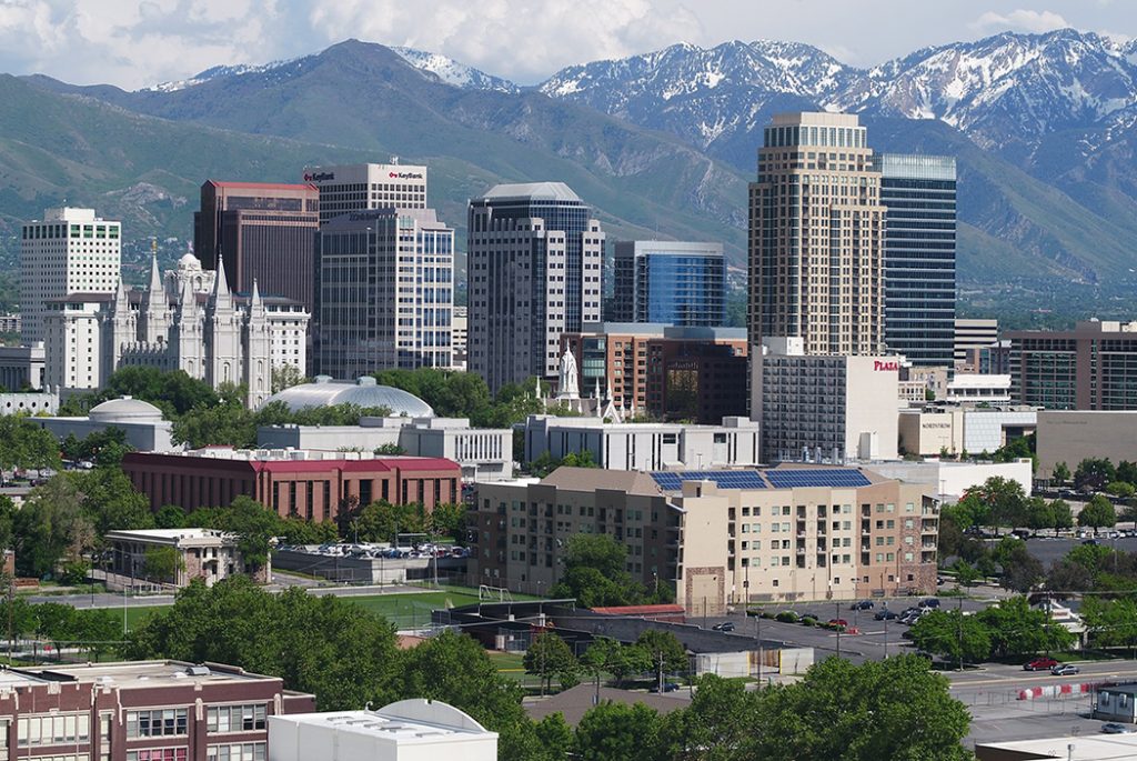 Photo of downtown Salt Lake City with snow-capped mountains in the background.