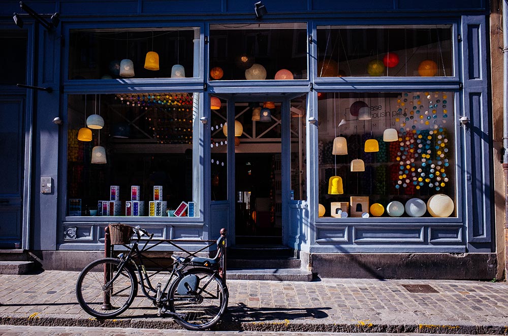 Photo of a bike in front of a cute shop in Lille, France.