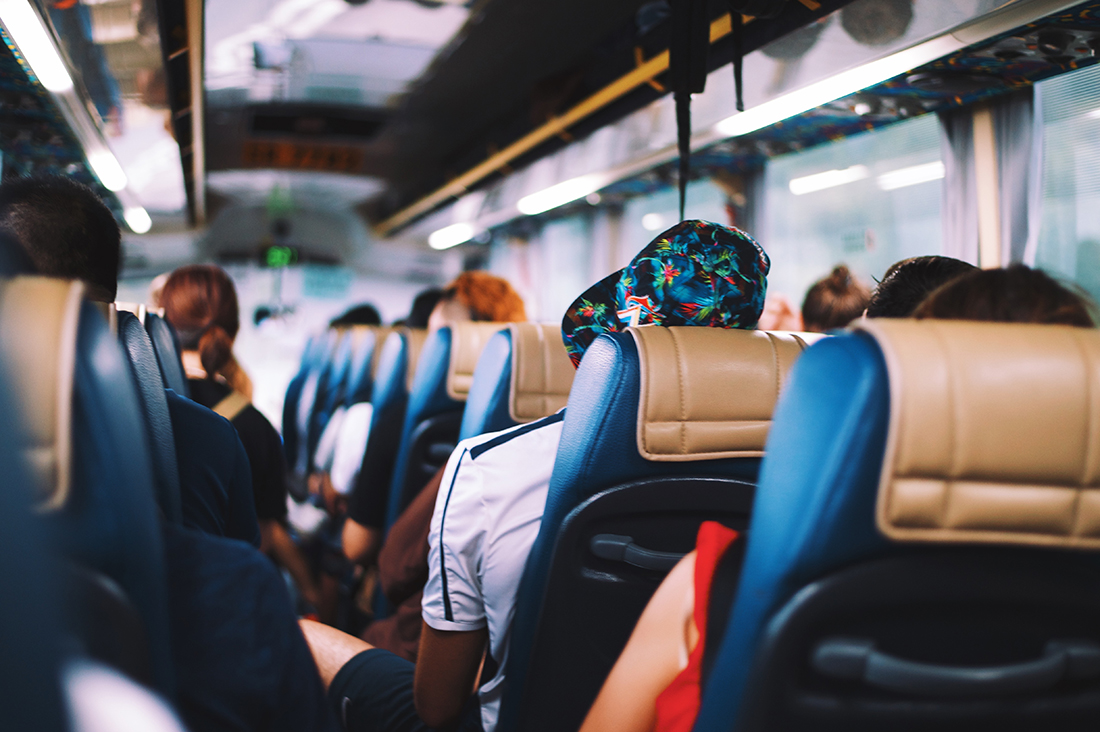 Photo of people seated on a bus.